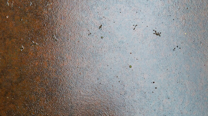 Rusty metal in the rain under the sunlight. Wet rusty metal surface