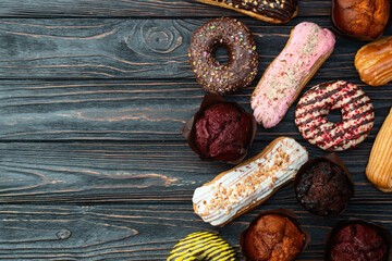 Sweet bakery mix . Donuts , eclair and muffins . Food photography . Top view