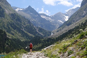 Scenery of Pyrenees National Park. Silhouettes of people on trail from Cauterets to lake Lac de Gaube. France	