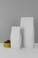 Foil plastic bag packaging with zipper and pile of seed for pet food or roasted coffee beans or tea, template isolated on a white background. Package mock-up