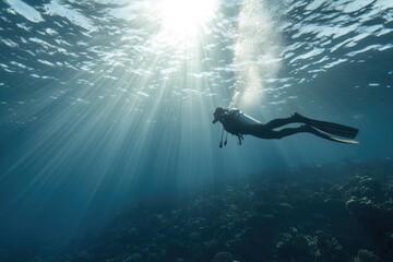 Fototapeta premium Underwater journey: diver descending, thrill of exploring beneath the surface, surrounded by coral reefs and aquatic life, adventure and tranquility of the diving experience