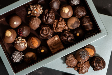 Box with a wide variety of chocolate bonbons.