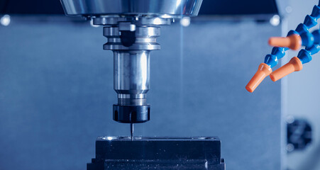 Modern CNC milling machine during operation. Produced cutting metal parts, industry heavy factory