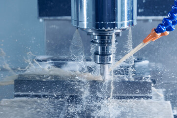 Working closeup CNC turning cutting metal Industry machine iron tools with splash cutting fluid...