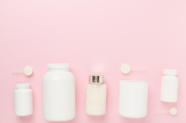 Jars with protein powder on color background, top view. Sports nutrition concept