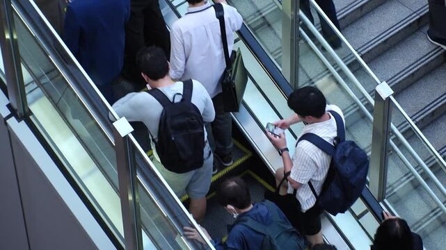 Back shot of crowd of people on escalator in Japan. Shot in busy rush hour, near the station. Japanese people, lifestyle, population and diversity concept video.