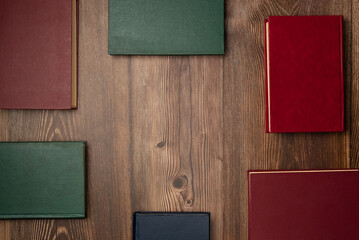 Books on wooden background from above. Flat lay, top view.
