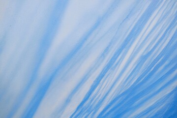 Abstract pattern featuring blue and white shades creating fluid lines on wall. Image depicts intricate textures and gentle color transitions