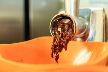 meat grinder filled with beef liver symbolizes the raw and unrefined nature of food preparation....