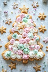 Fototapeta premium festive cream tart Christmas tree shaped cake made from layers of gingerbread cookies and cream cheese frosting, decorated with colorful pastel meringues and gingerbread stars