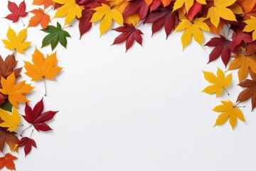 Colorful autumn leaves arranged in a corner on a white background, creating a frame for text or design.