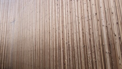 This is a closeup image of a wooden wall featuring a distinct striped pattern