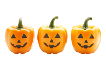 Orange bell peppers carved with jack-o'-lantern faces isolated on a white background, depicting a Halloween theme with a playful twist