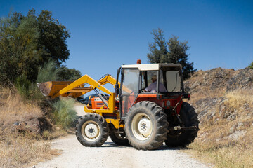 Tractor with front loader on country road