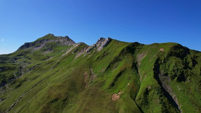 4K Aerial Drone video of the most beautiful mountain lake Schrecksee in Bavarian Alps with the cows feeding on lush green grass on a sunny day with blue skies and rocky hill tops surrounding