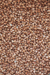 Buckwheat texture for background. Background of buckwheat grains, close-up, buckwheat kernels, dietary nutrition.  