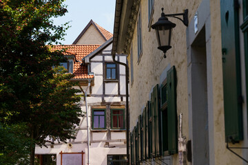 Historic architecture and charming streets of Waltershausen, Germany, showcasing half-timbered buildings and vibrant greenery in a sunny afternoon