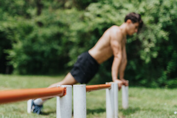A fit man exercising in nature, performing push-ups on a sunny day surrounded by lush greenery.