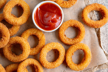 Fried onion rings with mozzarella or plain. Delicious onion rings on table