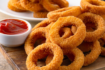 Fried onion rings with mozzarella or plain. Delicious onion rings on table