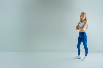 Fototapeta premium sporty young teenage girl in sport suit, leggings, top