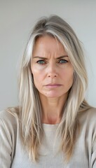 Blonde middle aged woman serious angry sad face portrait white background