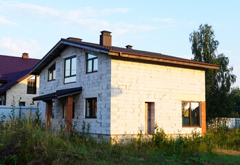 Suburb House construction. Country house, cottage, villa. Home outside city. Country house, green lawn. Family house in Suburb. Dream country home for family. Housing. Suburban Home Exterior, building