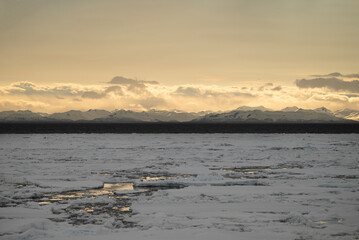 Stunning sunset over mountains and sea on wild natural islands in the northern region of the world,...