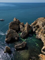 This aerial photo captures the stunning rock formations and turquoise waters at Ponta da Piedade in Lagos, Algarve. 