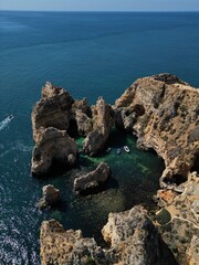 This aerial photo captures the stunning rock formations and turquoise waters at Ponta da Piedade in Lagos, Algarve. 