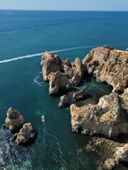 This aerial photo captures the stunning rock formations and turquoise waters at Ponta da Piedade in Lagos, Algarve. 