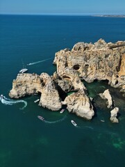 This aerial photo captures the stunning rock formations and turquoise waters at Ponta da Piedade in Lagos, Algarve. 