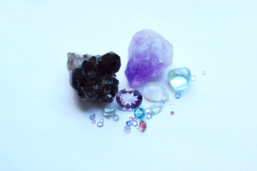 Beautiful faceted natural stones of sapphires, topazes and amethysts on a white background.