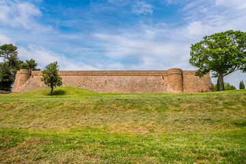 A close up view towards the wall of the Fortress Albornoz in the city in Urbino, Italy in summertime