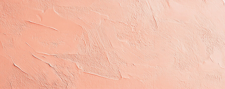 A light pastel coral surface with a fine, grainy texture. The warm, soft tone and delicate texture create a cheerful and inviting background.