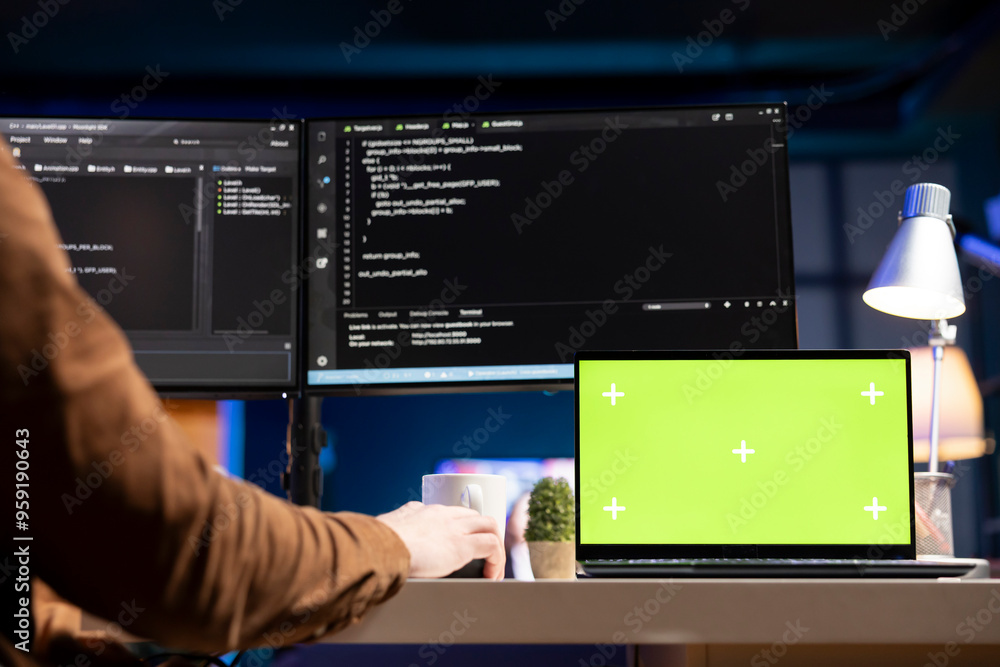 Poster admin using green screen laptop to filter malicious traffic from cybercriminals attempting to corrup