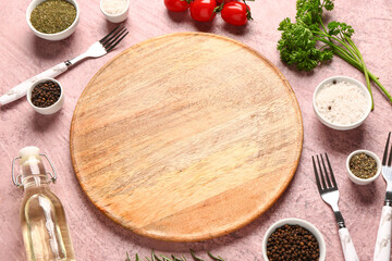 Composition with wooden cutting board, fresh vegetables and spices on color background