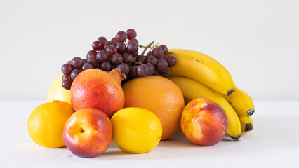 Close-up of different fresh fruits, pomegranate, banana, orange