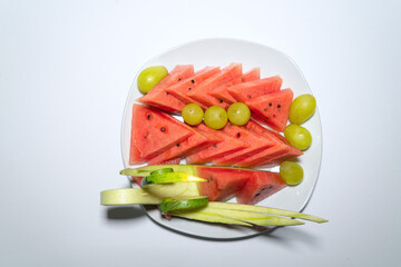 Watermelon platter with green grapes, fruit art platter on white table, top view