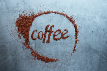 Word coffee on cement background, creative photo, top view