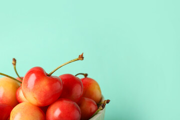 Sweet yellow cherries on turquoise background