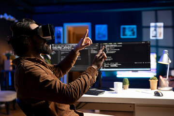 Man doing software quality assurance, reading source code using high tech VR headset. Developer...