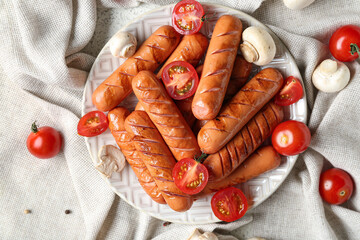 Plate with tasty grilled sausages on table