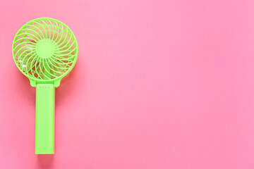 Modern manual fan on pink background