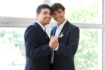 Happy gay couple dancing on their wedding day