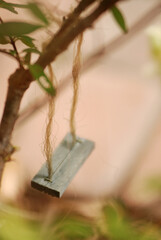 swing on branch, closeup in miniature