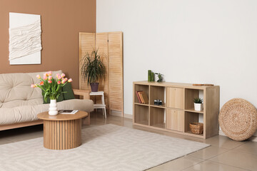 Interior of modern living room with sofa, chest of drawers and 3D textile artwork