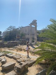 Greek temple of heracles in kos with a girl looking at it
