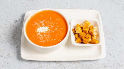 Tomato soup bowl with crackers