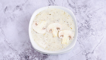 Creamy mushroom soup bowl top view	